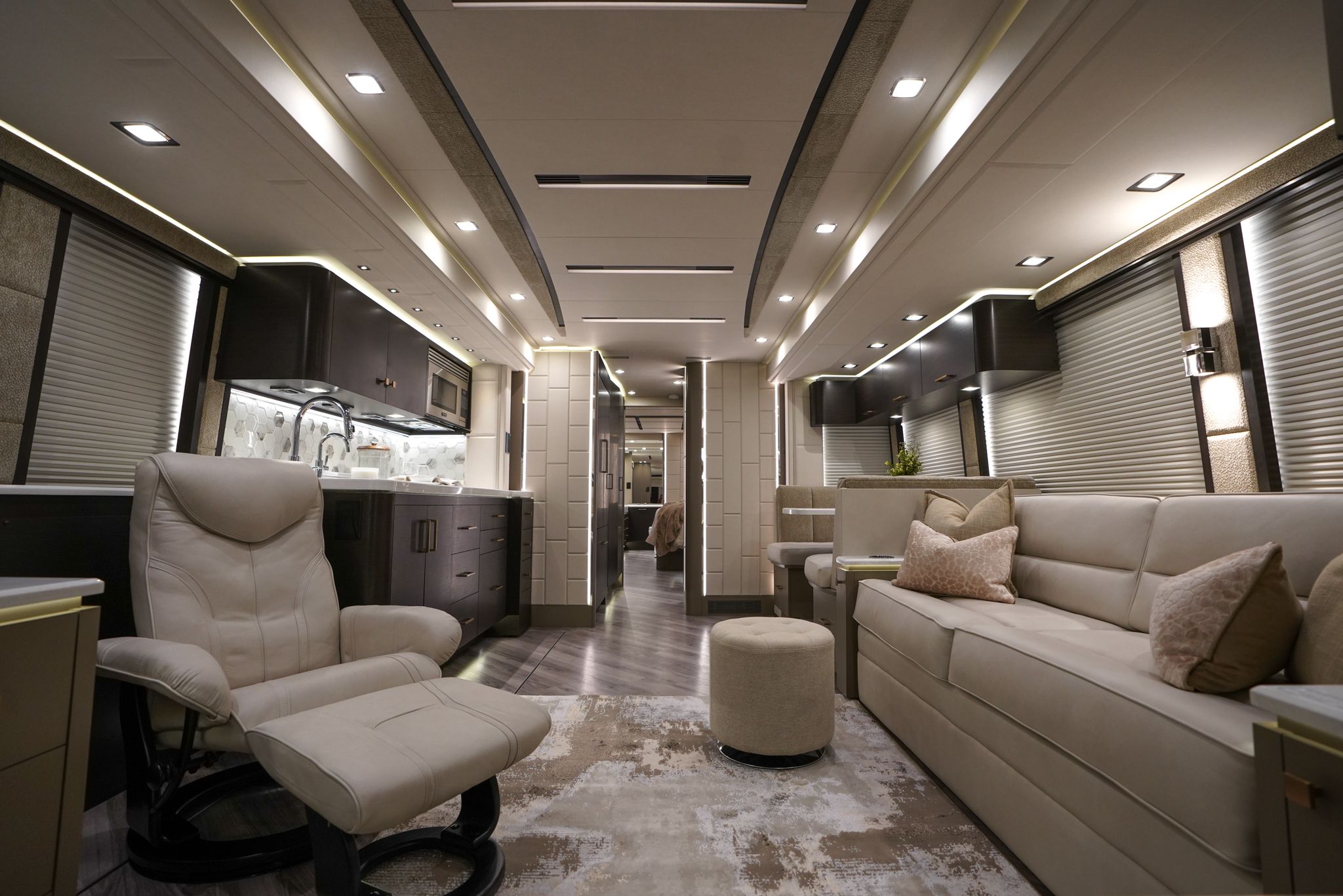 A brilliant lit luxury coach cabin with wood and marble furnishings