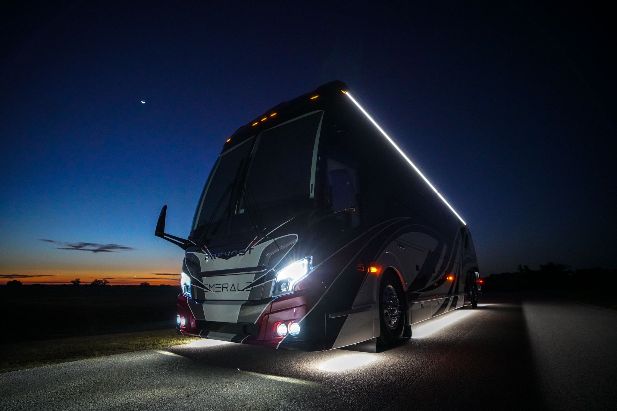 A coach parked in front of a starry sky