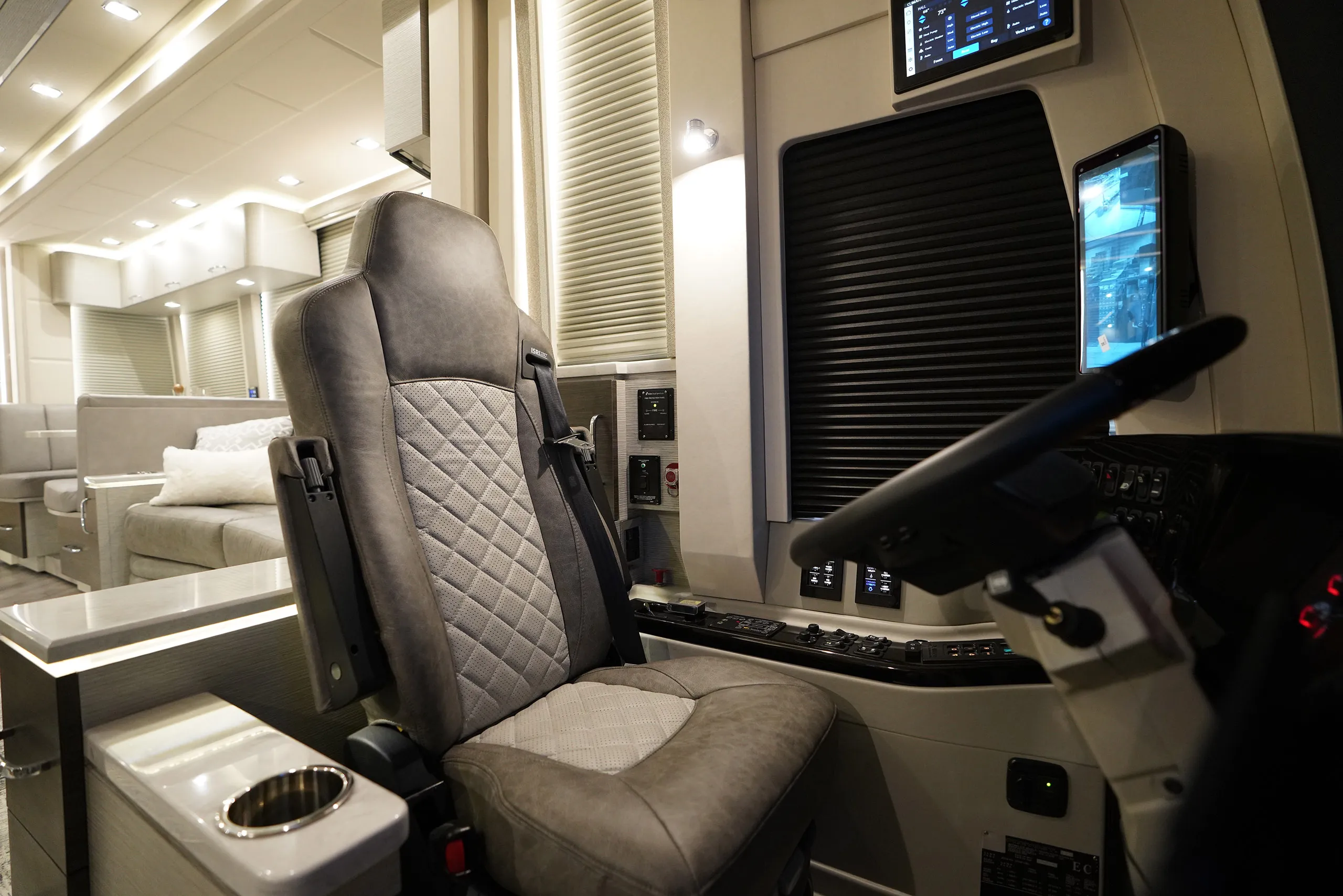 The command center of a luxury coach, complete with monitors and a smooth leather chair