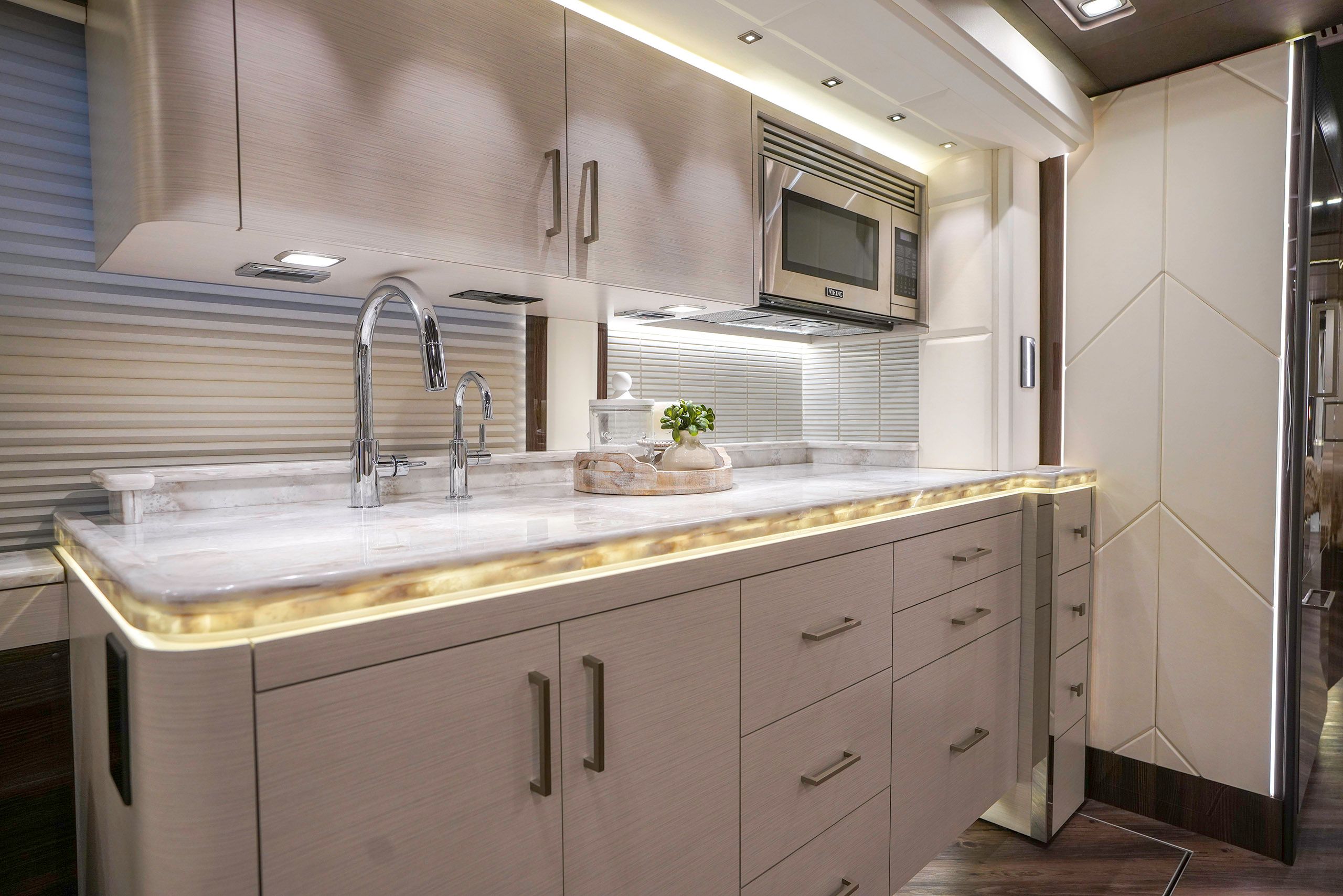 A brilliantly lit cabin interior featuring a kitchen galley